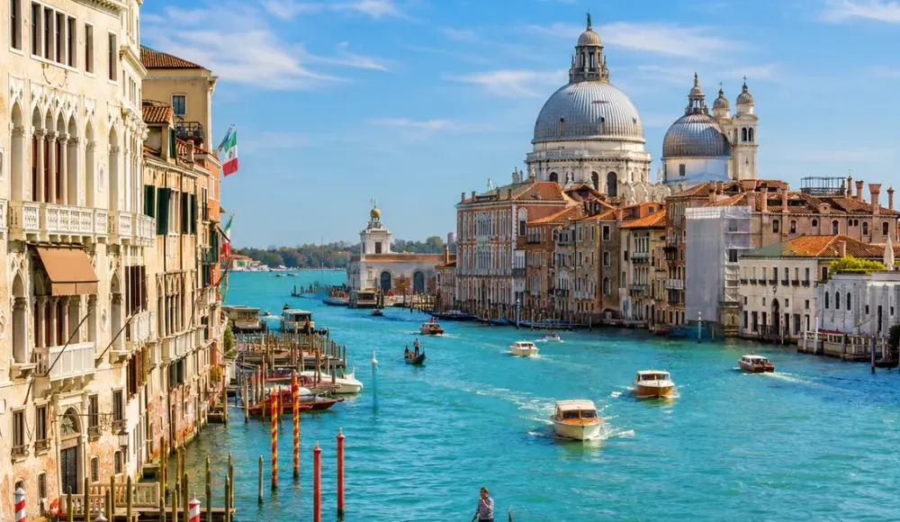 Venice city tour with Grand Canal, gondolas, historic bridges, colorful buildings, and bright morning atmosphere.