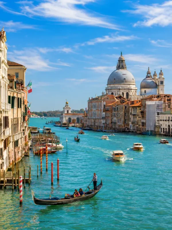 Venice city tour with Grand Canal, gondolas, historic bridges, colorful buildings, and bright morning atmosphere.