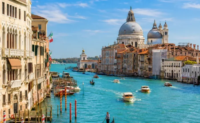 Venice city tour with Grand Canal, gondolas, historic bridges, colorful buildings, and bright morning atmosphere.