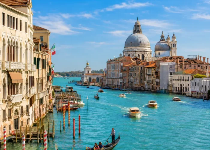 Venice city tour with Grand Canal, gondolas, historic bridges, colorful buildings, and bright morning atmosphere.