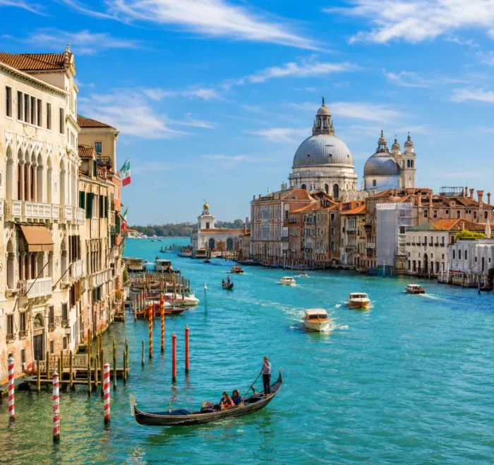 Venice city tour with Grand Canal, gondolas, historic bridges, colorful buildings, and bright morning atmosphere.