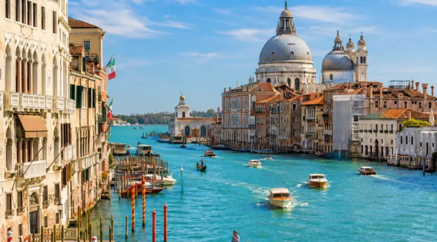 Venice city tour with Grand Canal, gondolas, historic bridges, colorful buildings, and bright morning atmosphere.