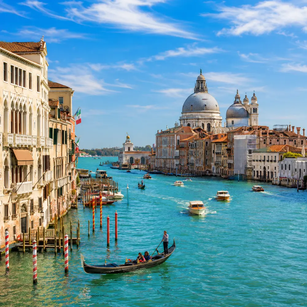 Venice city tour with Grand Canal, gondolas, historic bridges, colorful buildings, and bright morning atmosphere.