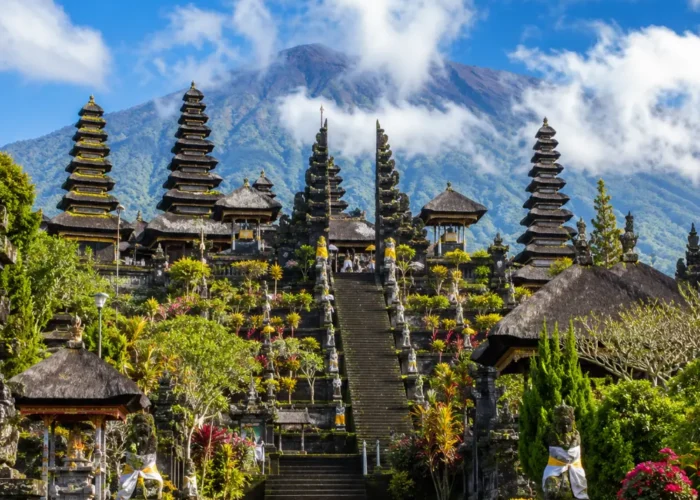 Besakih Temple Bali with Mount Agung views, traditional temple gates, lush greenery, and bright morning atmosphere.