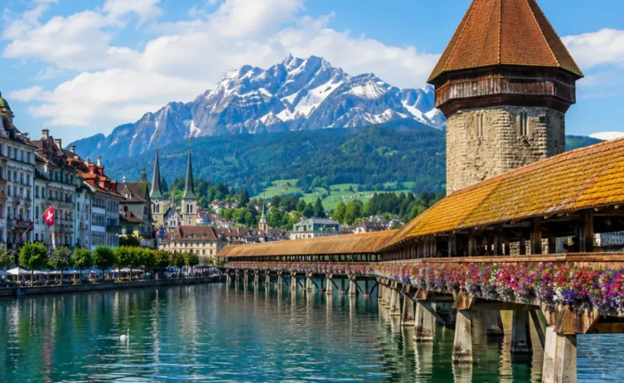 Lucerne city tour with Chapel Bridge, Lake Lucerne, Swiss Alps, historic buildings, and bright morning atmosphere.