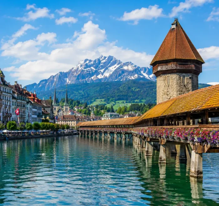 Lucerne city tour with Chapel Bridge, Lake Lucerne, Swiss Alps, historic buildings, and bright morning atmosphere.