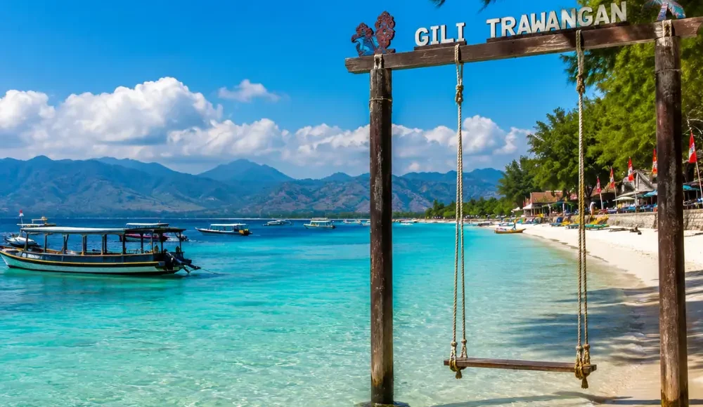 Gili Trawangan Indonesia with turquoise beach, clear sea, tropical palms, and bright morning island atmosphere.