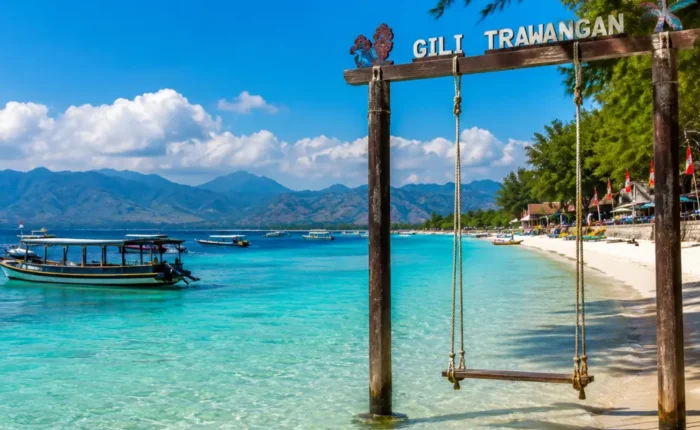 Gili Trawangan Indonesia with turquoise beach, clear sea, tropical palms, and bright morning island atmosphere.