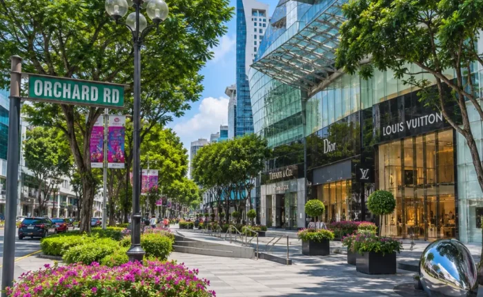 Orchard Road Singapore with luxury malls, tree-lined boulevards, modern city views, and bright morning atmosphere.