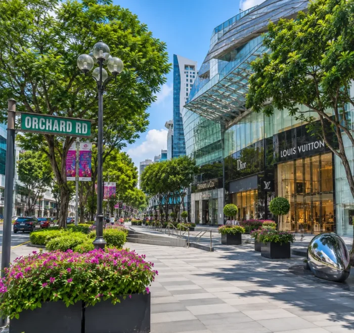 Orchard Road Singapore with luxury malls, tree-lined boulevards, modern city views, and bright morning atmosphere.