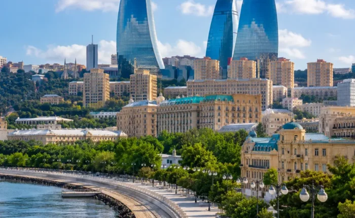 Baku city skyline with Flame Towers, Caspian Sea Boulevard, modern architecture, and bright morning atmosphere.