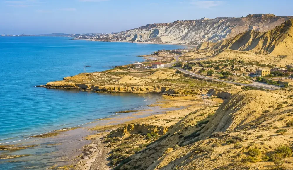 Absheron Peninsula in Azerbaijan with Ateshgah fire temple, rocky landscape, clear sky, and bright morning light.