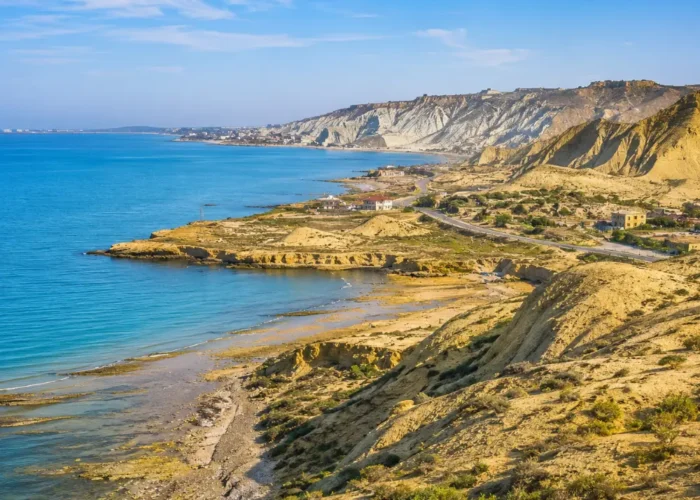 Absheron Peninsula in Azerbaijan with Ateshgah fire temple, rocky landscape, clear sky, and bright morning light.
