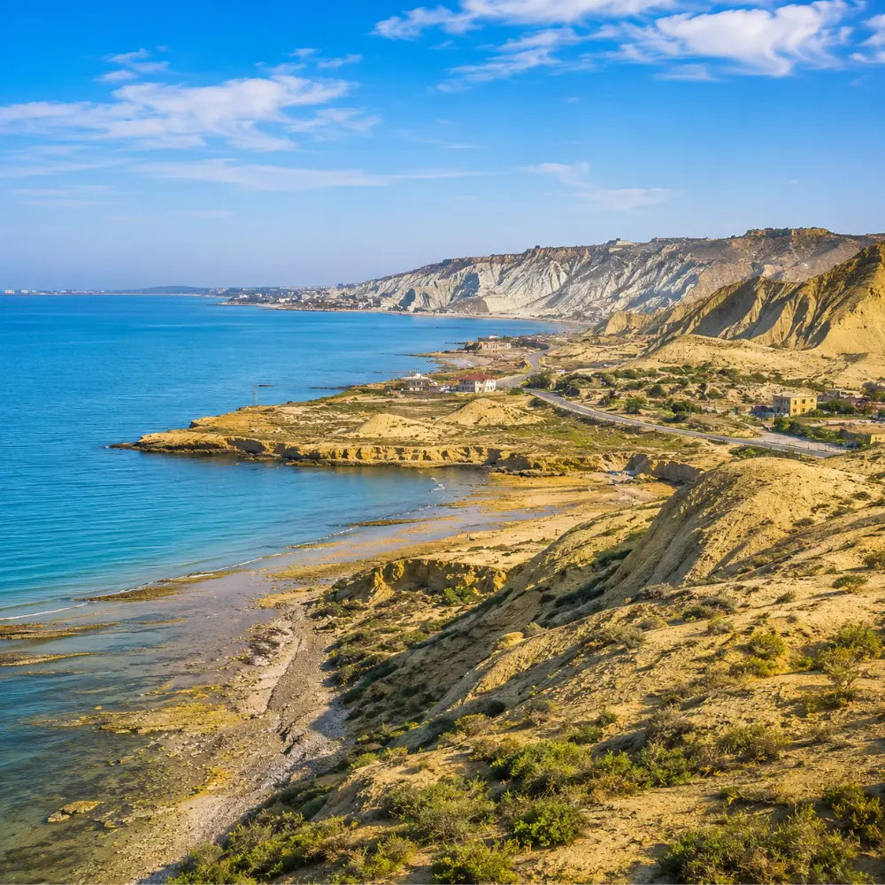 Absheron Peninsula in Azerbaijan with Ateshgah fire temple, rocky landscape, clear sky, and bright morning light.