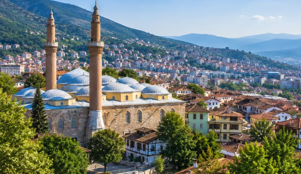 Bursa Turkey with Grand Mosque, green mountain scenery, Ottoman architecture, and bright morning atmosphere.