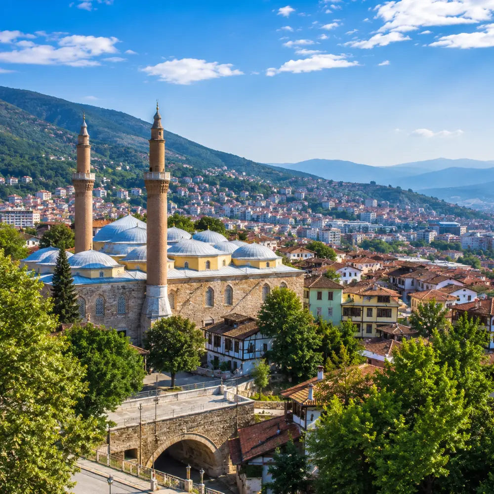Bursa Turkey with Grand Mosque, green mountain scenery, Ottoman architecture, and bright morning atmosphere.