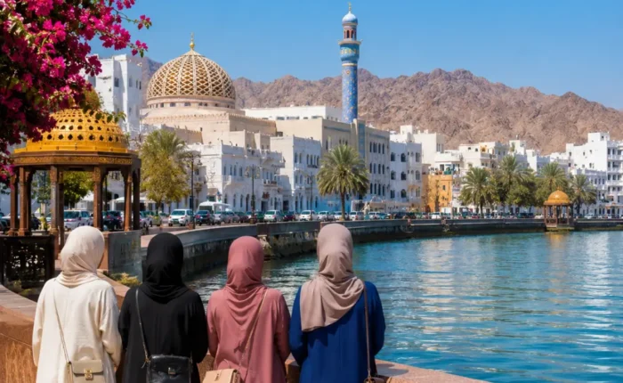 Women-only group enjoying the scenic Muscat Corniche with Sultan Qaboos Mosque and mountains in Oman
