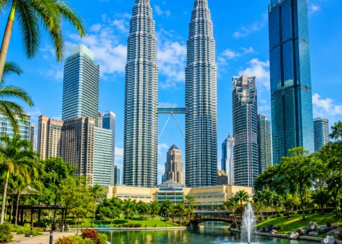 Ultra-clear square view of Kuala Lumpur with the Petronas Twin Towers, tropical greenery, and a premium modern cityscape.