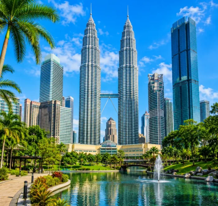Ultra-clear square view of Kuala Lumpur with the Petronas Twin Towers, tropical greenery, and a premium modern cityscape.