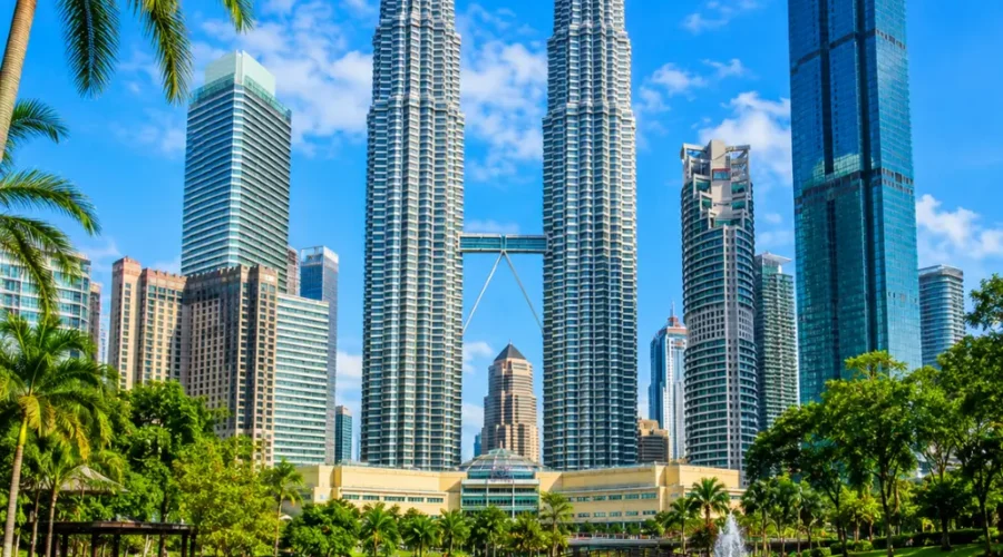 Ultra-clear square view of Kuala Lumpur with the Petronas Twin Towers, tropical greenery, and a premium modern cityscape.