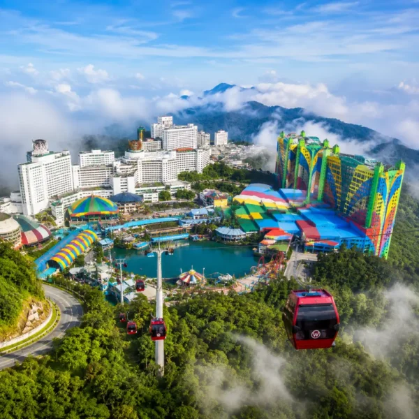 Luxury view of Genting Highlands with modern hilltop resorts, lush rainforest, cable cars, and misty mountain scenery.
