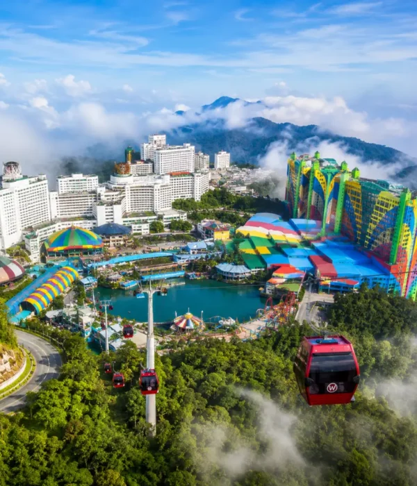 Luxury view of Genting Highlands with modern hilltop resorts, lush rainforest, cable cars, and misty mountain scenery.