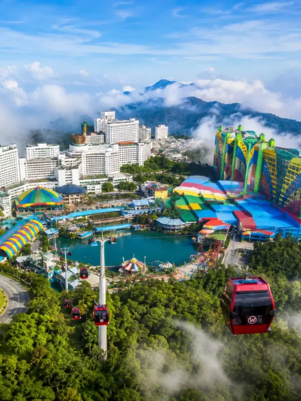 Luxury view of Genting Highlands with modern hilltop resorts, lush rainforest, cable cars, and misty mountain scenery.