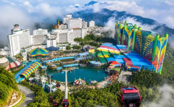 Luxury view of Genting Highlands with modern hilltop resorts, lush rainforest, cable cars, and misty mountain scenery.