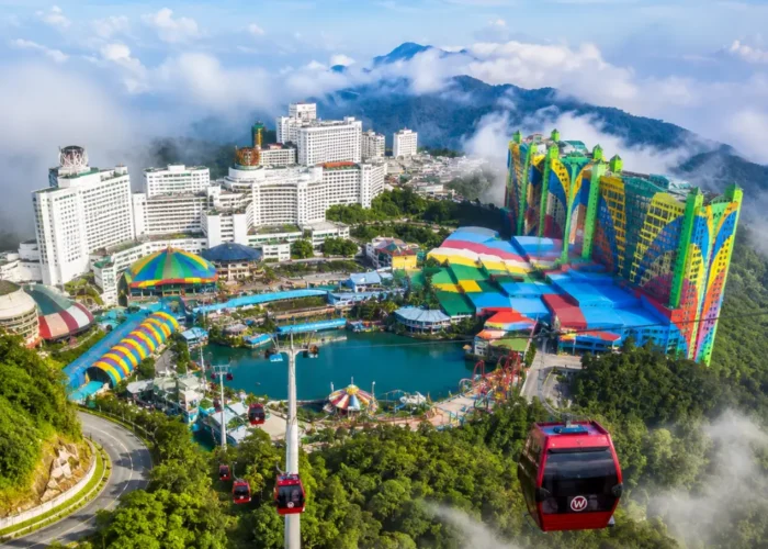 Luxury view of Genting Highlands with modern hilltop resorts, lush rainforest, cable cars, and misty mountain scenery.
