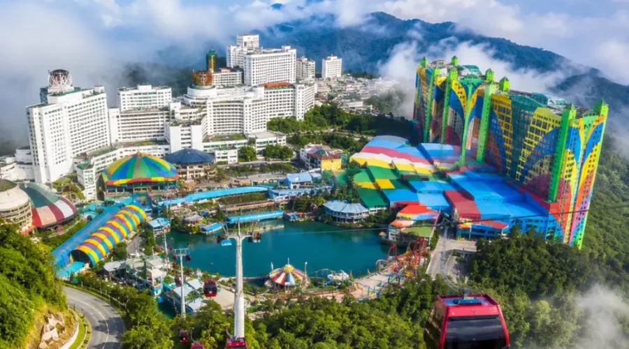 Luxury view of Genting Highlands with modern hilltop resorts, lush rainforest, cable cars, and misty mountain scenery.
