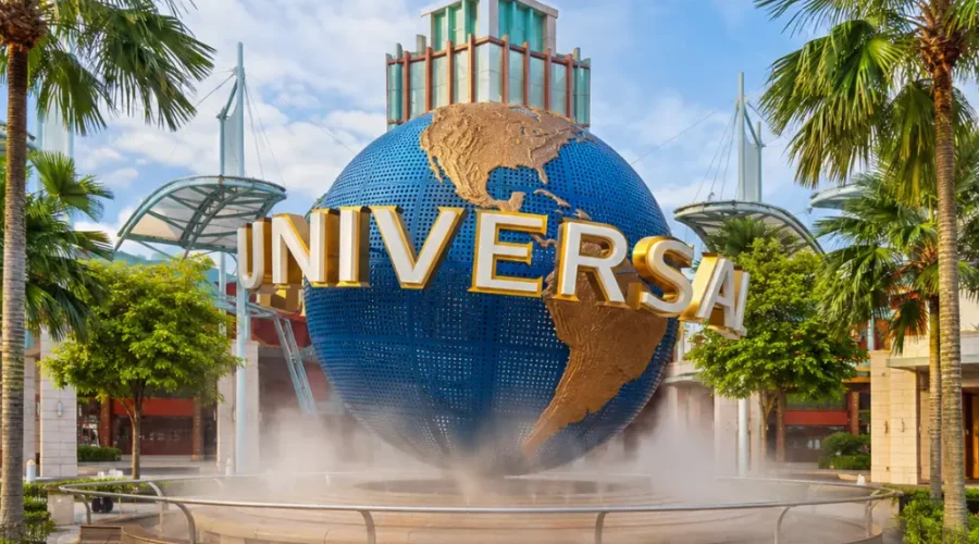 Universal Studios Singapore entrance with iconic globe, tropical palms, and bright morning travel atmosphere.