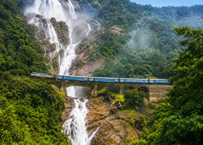 Dudhsagar Falls in Goa with powerful white cascades, lush Western Ghats forest and clear morning daylight.