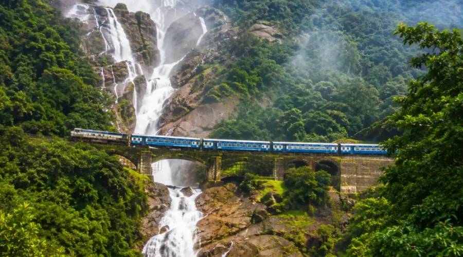 Dudhsagar Falls in Goa with powerful white cascades, lush Western Ghats forest and clear morning daylight.