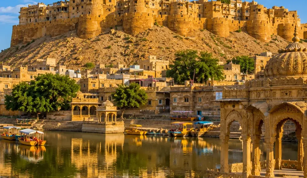 Jaisalmer fort with golden sandstone architecture, desert dunes and clear morning daylight in Rajasthan.