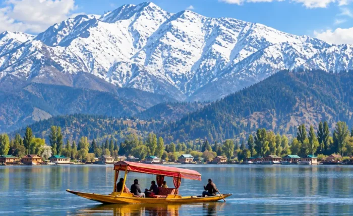 Shikara boat on Dal Lake in Srinagar, Kashmir, with snow-capped Himalayan mountains and scenic waterfront views