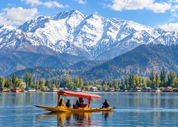 Shikara boat on Dal Lake in Srinagar, Kashmir, with snow-capped Himalayan mountains and scenic waterfront views