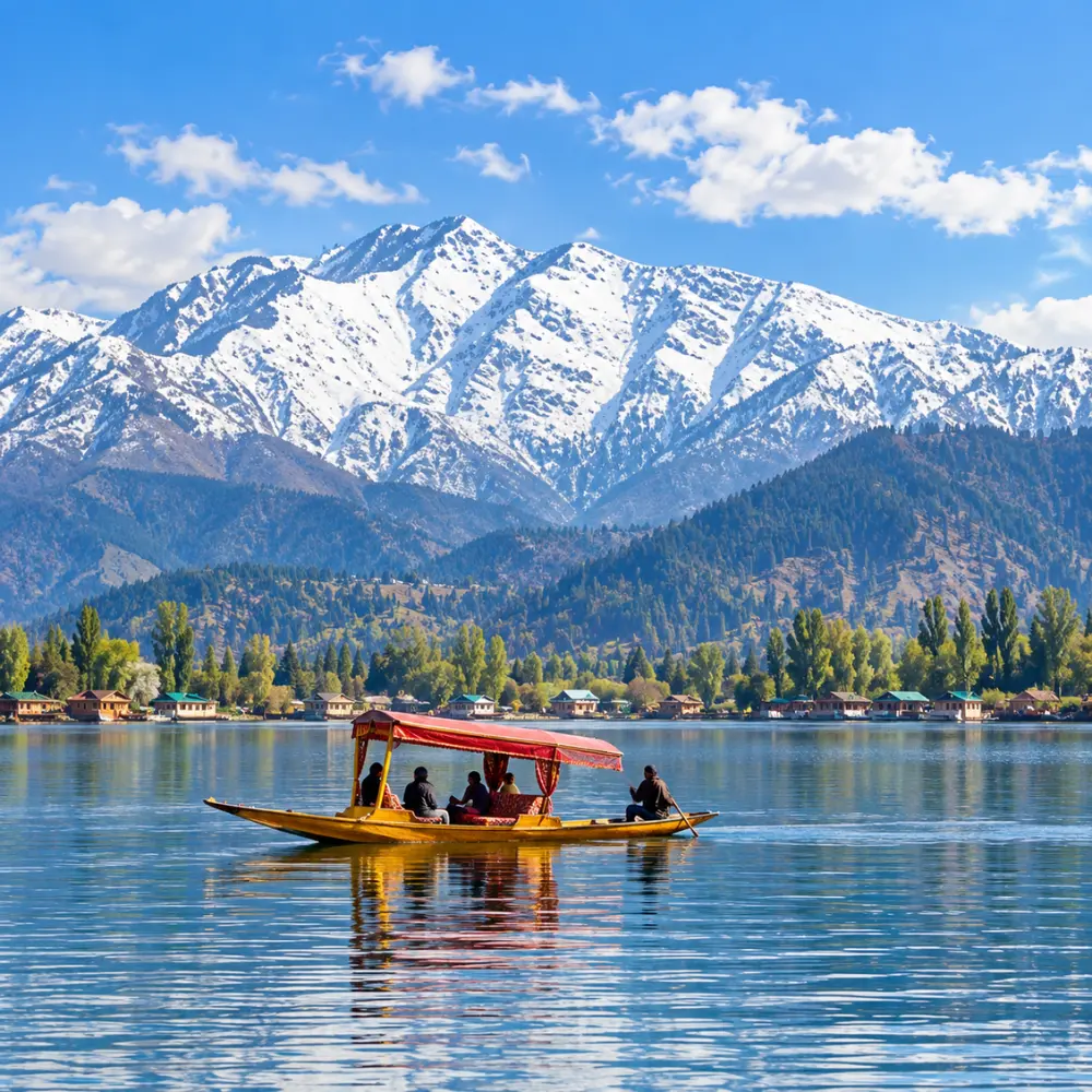 Shikara boat on Dal Lake in Srinagar, Kashmir, with snow-capped Himalayan mountains and scenic waterfront views